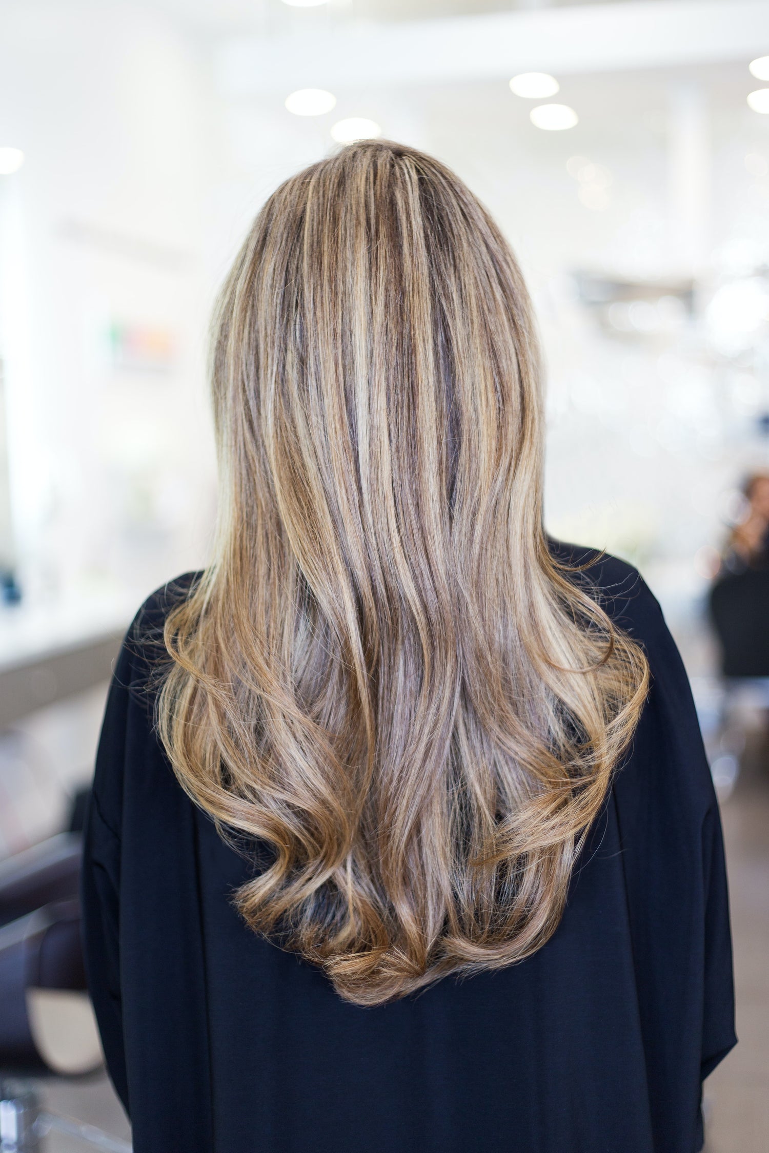 woman standing back with a long blond hair